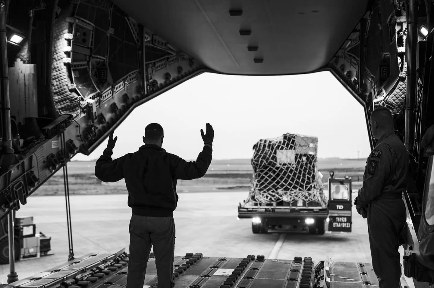 Marshaller guiding tactical airlift loadout